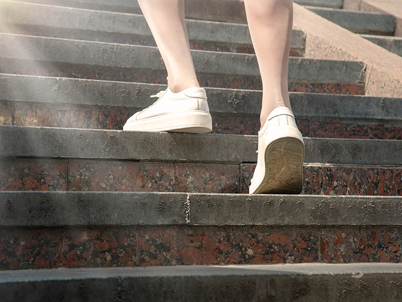 Feet in sneakers going up the stairs